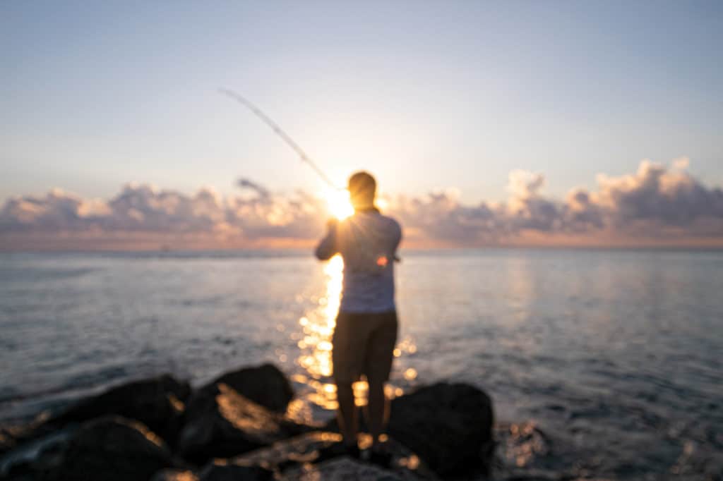 Man fishing on rocks